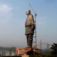 The under-construction statue of unity stands facing the Sardar Sarovar Dam.